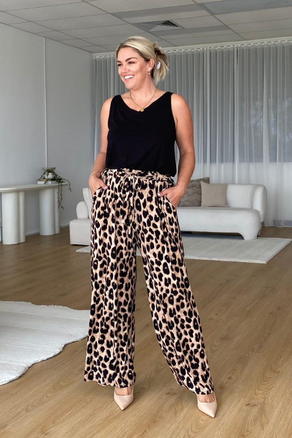 Model in Luna Bamboo Sleeveless Top in Black styled with Alexa Pants in Luxe Leopard for an elevated day-to-night outfit.