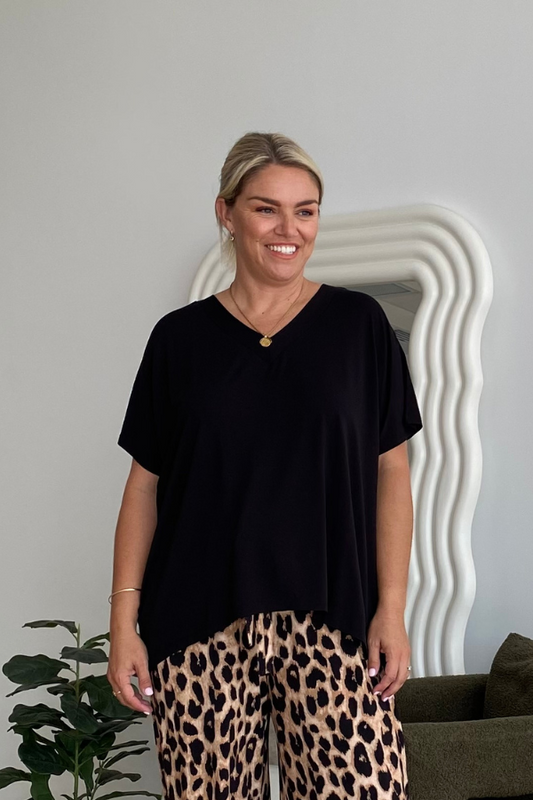 Model wearing Olivia Bamboo Top in Black styled with Luxe Leopard Alexa Pants for a bold everyday look.