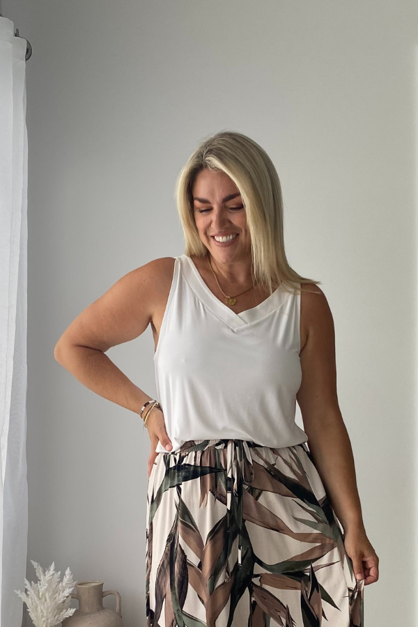 Model wearing Luna Bamboo Sleeveless Top in White styled with Holly bamboo skirt for a versatile day-to-night look.