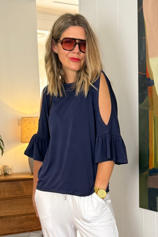 Close-up of Sofia Top in navy by Natali The Label—soft bamboo fabric with elegant cold shoulder design, frill sleeve detail, and timeless round neckline.