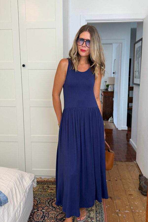 Woman wearing the Cassia Bamboo Dress in Navy, front view showing the fitted bodice and gathered skirt
