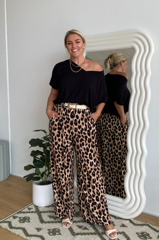 Model in Olivia Bamboo Top in Black styled with Alexa Pants in Luxe Leopard print, perfect desk-to-dinner look.