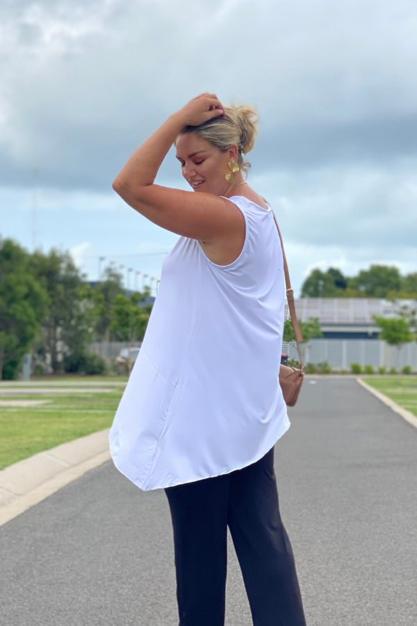 Side view of Delia Bamboo Top in white showing asymmetric hemline