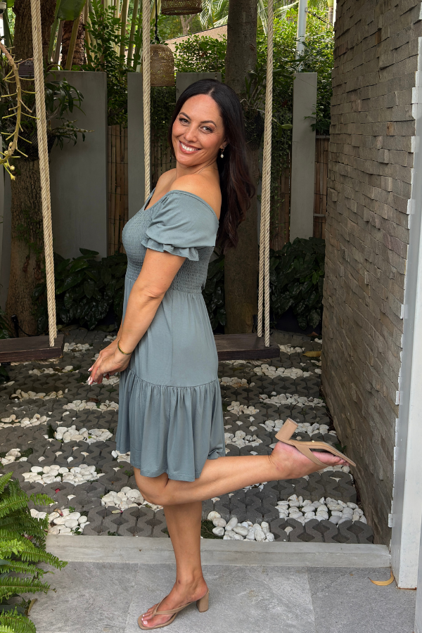 Gemma Bamboo Dress in Sage — worn off-shoulder, side view showing tiered hem