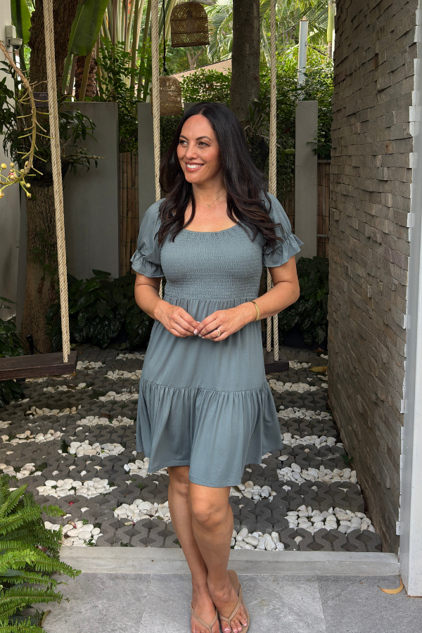 Gemma Bamboo Dress in Sage — shirred square-neck mini dress with ruffle sleeves, styled with sandals